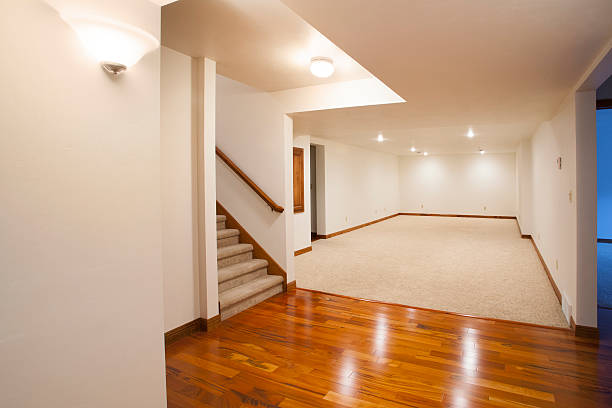Spacious remodeled basement with hardwood floors, recessed lighting, and neutral walls in Macomb