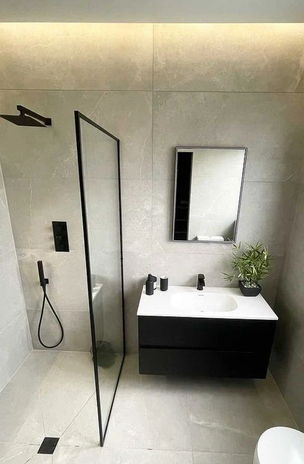 Modern bathroom with glass shower and sleek vanity in Utica City.